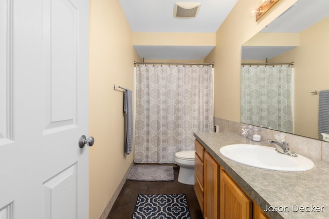 full bathroom with toilet and vanity