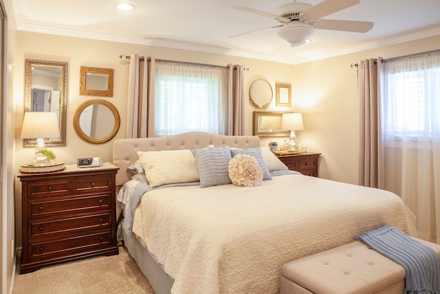 bedroom featuring ornamental molding, light carpet, and ceiling fan