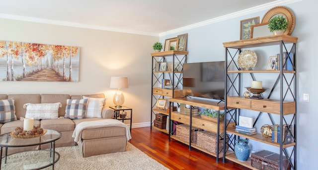 living room with wood finished floors, crown molding, and baseboards