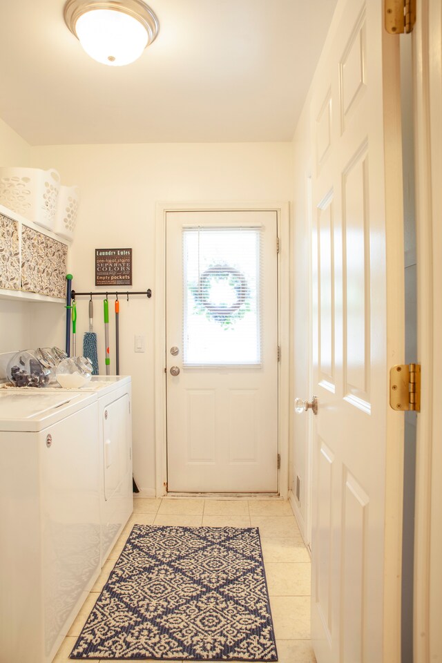 washroom with light tile patterned floors and washing machine and clothes dryer