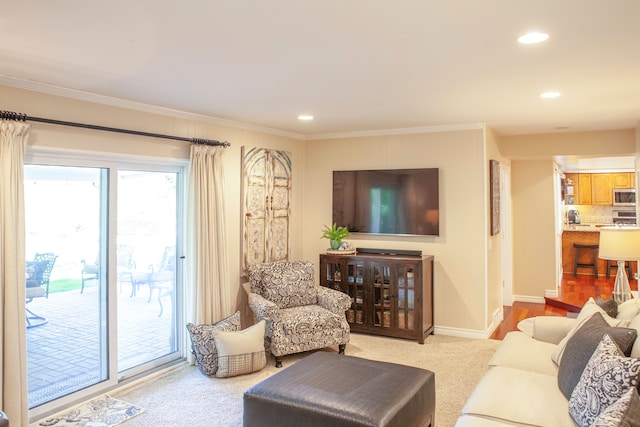 living room featuring recessed lighting, baseboards, ornamental molding, and light colored carpet