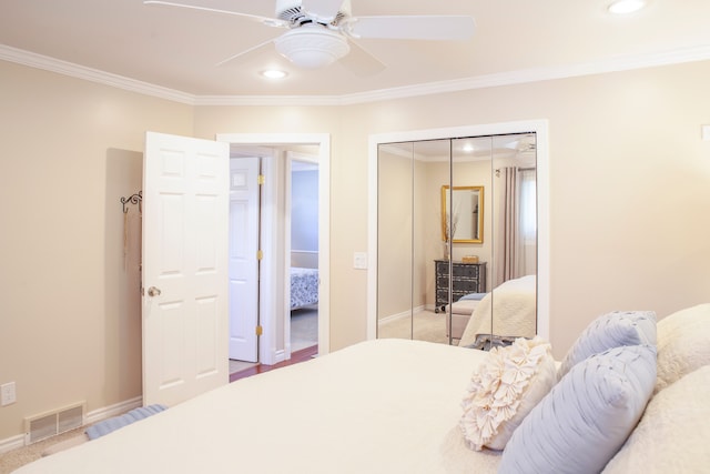 carpeted bedroom with crown molding, a closet, baseboards, recessed lighting, and a ceiling fan
