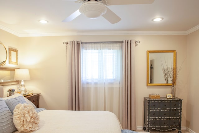 bedroom featuring ornamental molding, a ceiling fan, and baseboards