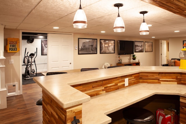 bar with decorative light fixtures, wood finished floors, and recessed lighting