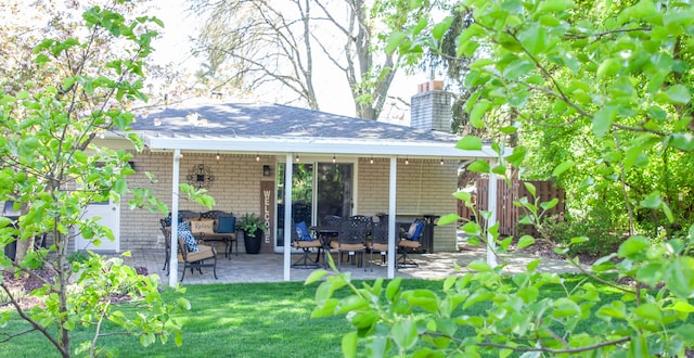 back of property with a patio area and a chimney