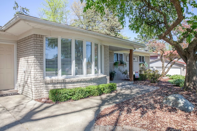 property entrance featuring brick siding