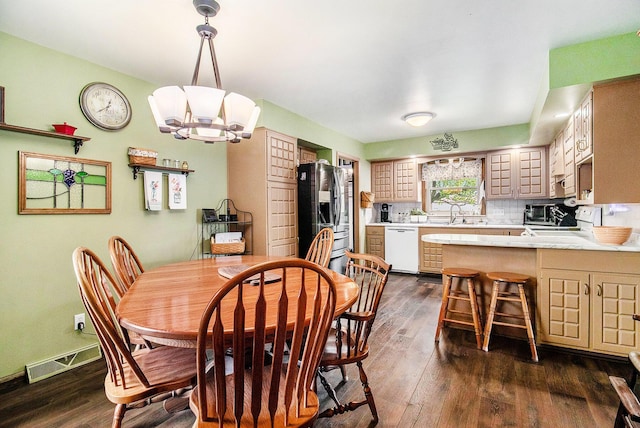 dining area featuring a chandelier and dark wood-style flooring