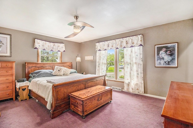 bedroom with multiple windows, carpet floors, a ceiling fan, and baseboards