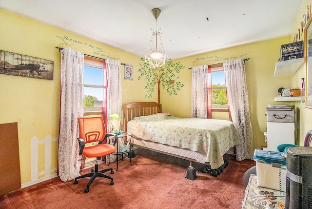 carpeted bedroom with a chandelier