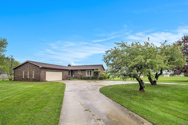 ranch-style house featuring driveway, an attached garage, a front lawn, and brick siding
