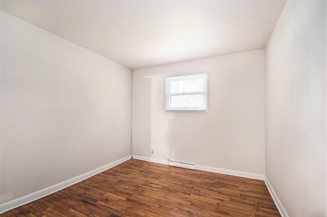 2 Fort St, Niles, MI 49120 - unfurnished room featuring a baseboard heating unit, dark wood finished floors, and baseboards
