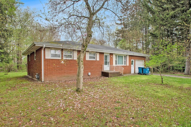 2 Fort St, Niles, MI 49120 - view of front facade featuring brick siding, a garage, and a front yard