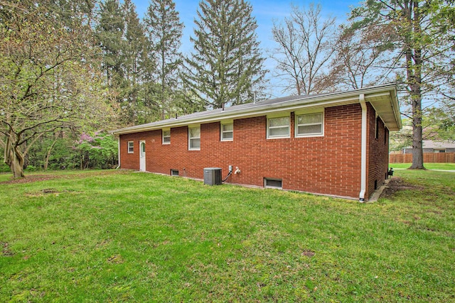2 Fort St, Niles, MI 49120 - rear view of house featuring a lawn, brick siding, and central AC