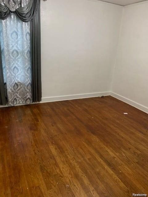 8097 Marlowe St, Detroit, MI 48228 - spare room featuring wood-type flooring and baseboards