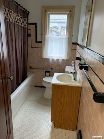 8097 Marlowe St, Detroit, MI 48228 - bathroom with tile walls, vanity, shower / bath combo with shower curtain, a wainscoted wall, and tile patterned flooring