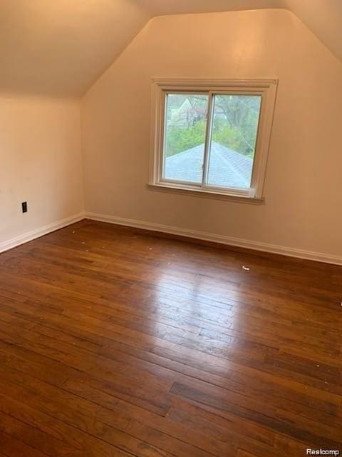 8097 Marlowe St, Detroit, MI 48228 - additional living space featuring dark wood-style flooring and vaulted ceiling