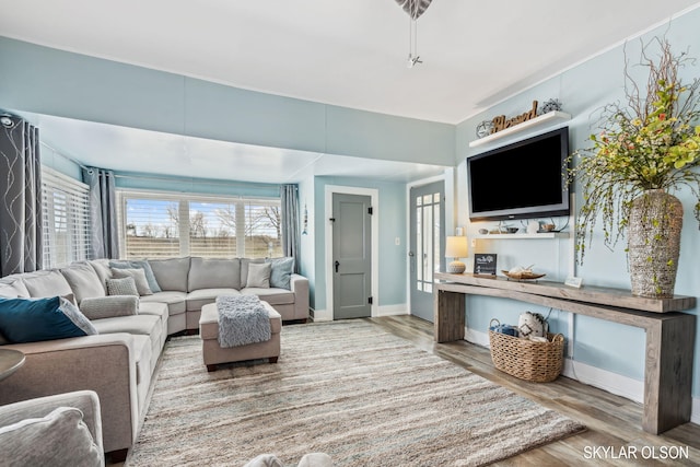 living room featuring wood finished floors and baseboards