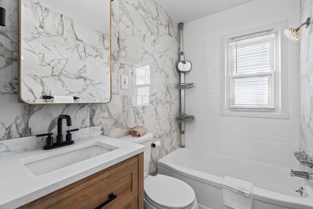 bathroom with toilet, vanity, tile walls, bathtub / shower combination, and tasteful backsplash