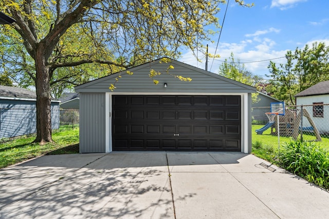 detached garage featuring fence
