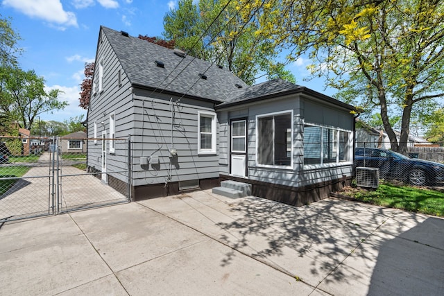 back of house featuring a gate, fence, central AC, a patio, and entry steps