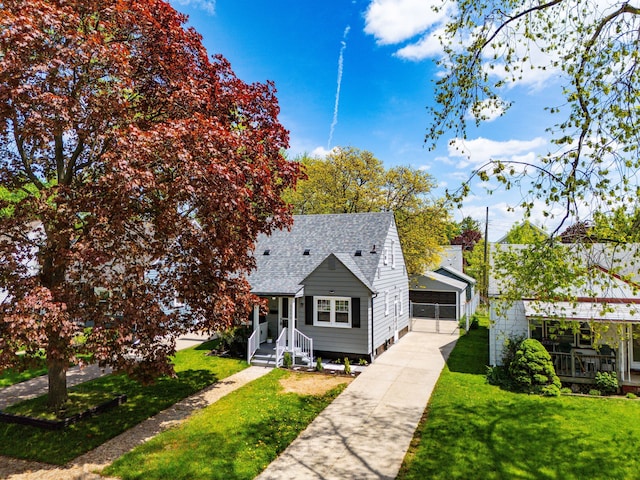 bungalow-style house with a shingled roof, a garage, and a front lawn