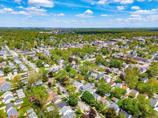 aerial view of property and surrounding area featuring nearby suburban area