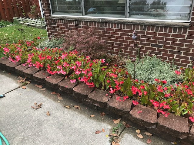 exterior view of fence and brick siding