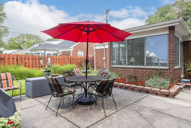 view of patio with fence and outdoor dining space