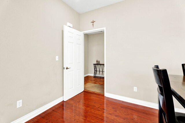 unfurnished office with wood finished floors and baseboards