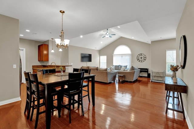 dining room featuring healthy amount of natural light, a ceiling fan, wood finished floors, and lofted ceiling