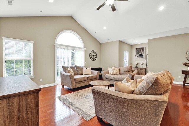 living area with ceiling fan, hardwood / wood-style flooring, recessed lighting, baseboards, and high vaulted ceiling