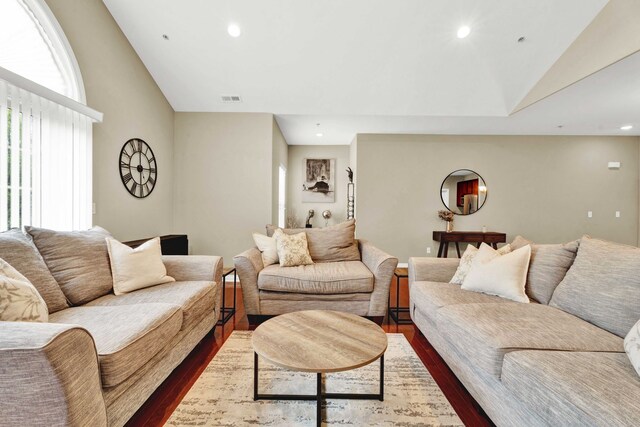 living room featuring vaulted ceiling, dark wood-type flooring, and recessed lighting