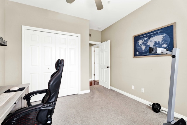 carpeted home office with ceiling fan and baseboards