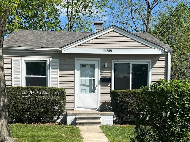 11389 Hupp Ave, Warren, MI 48089 - view of front of house featuring a chimney and roof with shingles