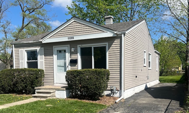 11389 Hupp Ave, Warren, MI 48089 - view of front of home with a chimney and roof with shingles