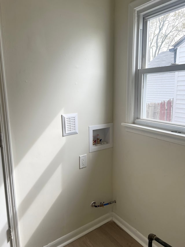 11389 Hupp Ave, Warren, MI 48089 - washroom featuring hookup for a washing machine, healthy amount of natural light, baseboards, and wood finished floors