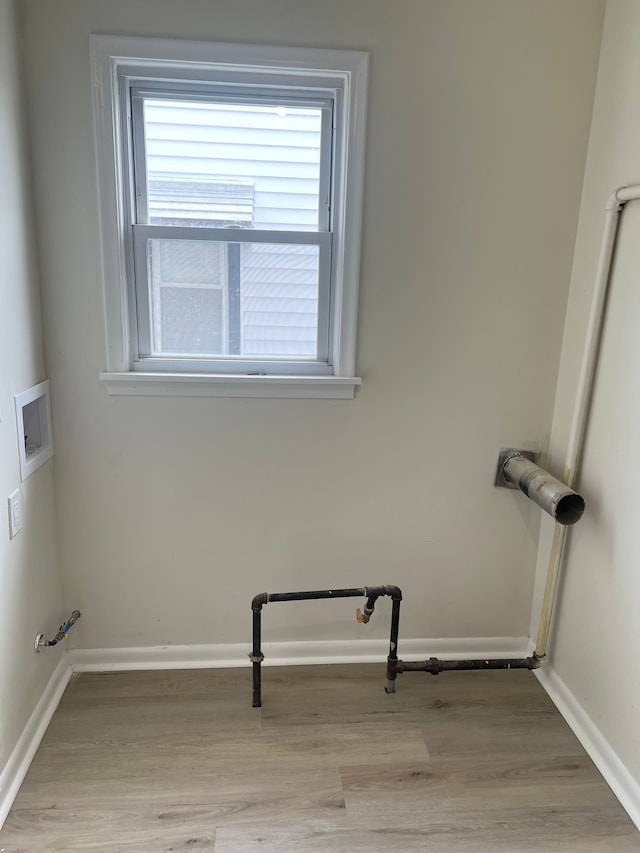 11389 Hupp Ave, Warren, MI 48089 - washroom featuring hookup for a washing machine, plenty of natural light, light wood-style flooring, and baseboards