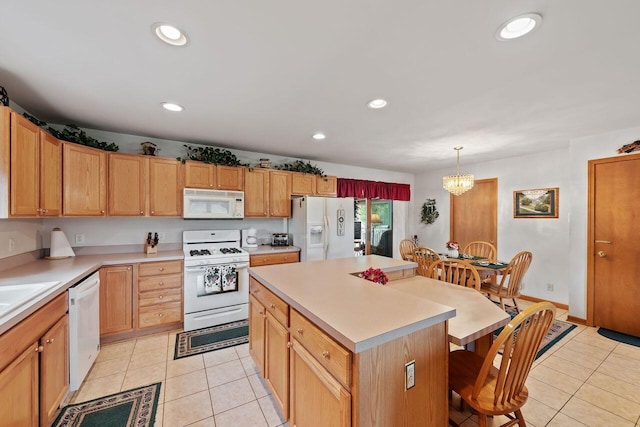 kitchen with white appliances, light tile patterned floors, a breakfast bar, a chandelier, and recessed lighting