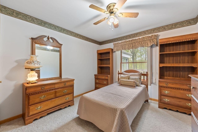 bedroom featuring light carpet, baseboards, and ceiling fan