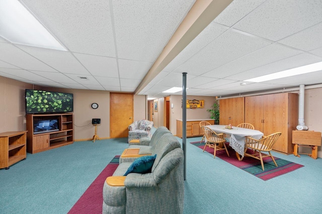 carpeted living room with a drop ceiling