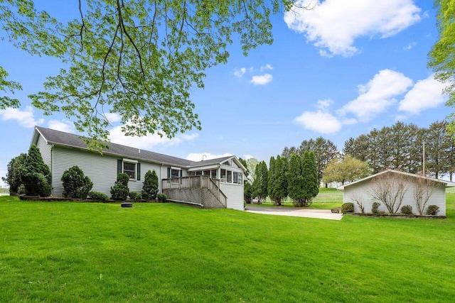view of grassy yard with a deck