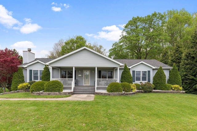 ranch-style house with covered porch, a chimney, a front yard, and roof with shingles