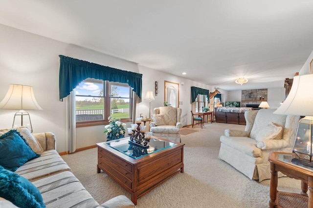 carpeted living room with baseboards and a fireplace