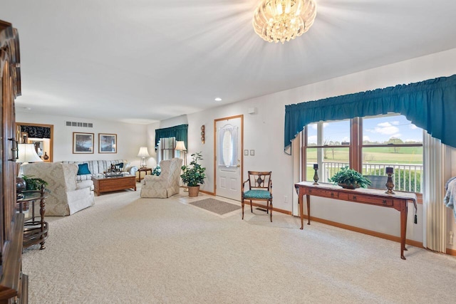 living room with carpet floors, baseboards, recessed lighting, and a chandelier