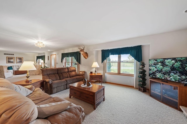 living area with light carpet and baseboards