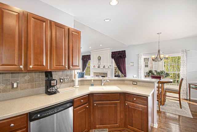 4261 Merriman Loop, Howell, MI 48843 - kitchen with stainless steel dishwasher, a sink, a peninsula, a chandelier, and healthy amount of natural light