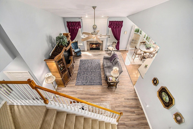 4261 Merriman Loop, Howell, MI 48843 - stairway with wood finished floors, a large fireplace, and baseboards