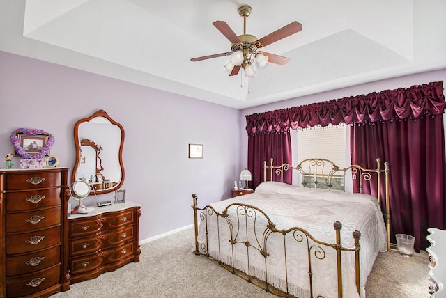 4261 Merriman Loop, Howell, MI 48843 - carpeted bedroom featuring a raised ceiling, baseboards, and ceiling fan