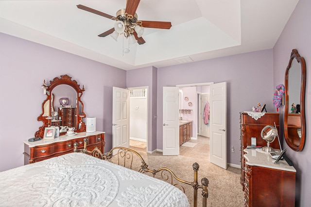 4261 Merriman Loop, Howell, MI 48843 - bedroom with light colored carpet, ensuite bathroom, baseboards, and ceiling fan