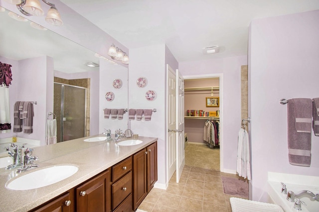 4261 Merriman Loop, Howell, MI 48843 - full bathroom with a stall shower, double vanity, tile patterned flooring, a bath, and a spacious closet